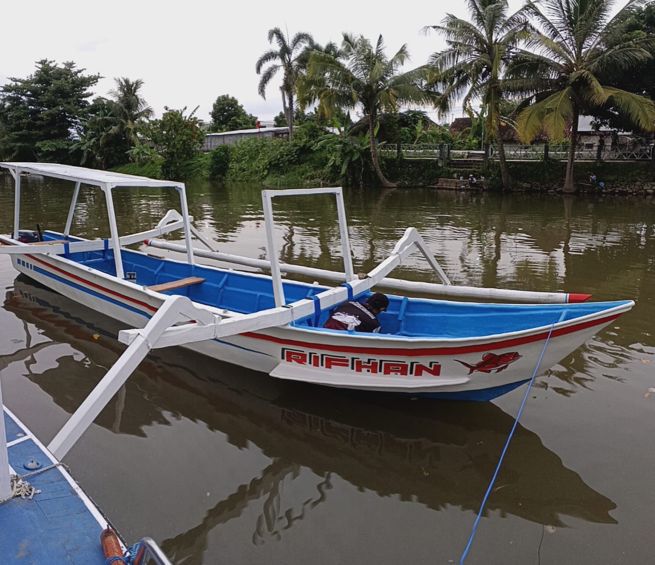 Traditional Lombok fishing boat moored at Ampenan river side