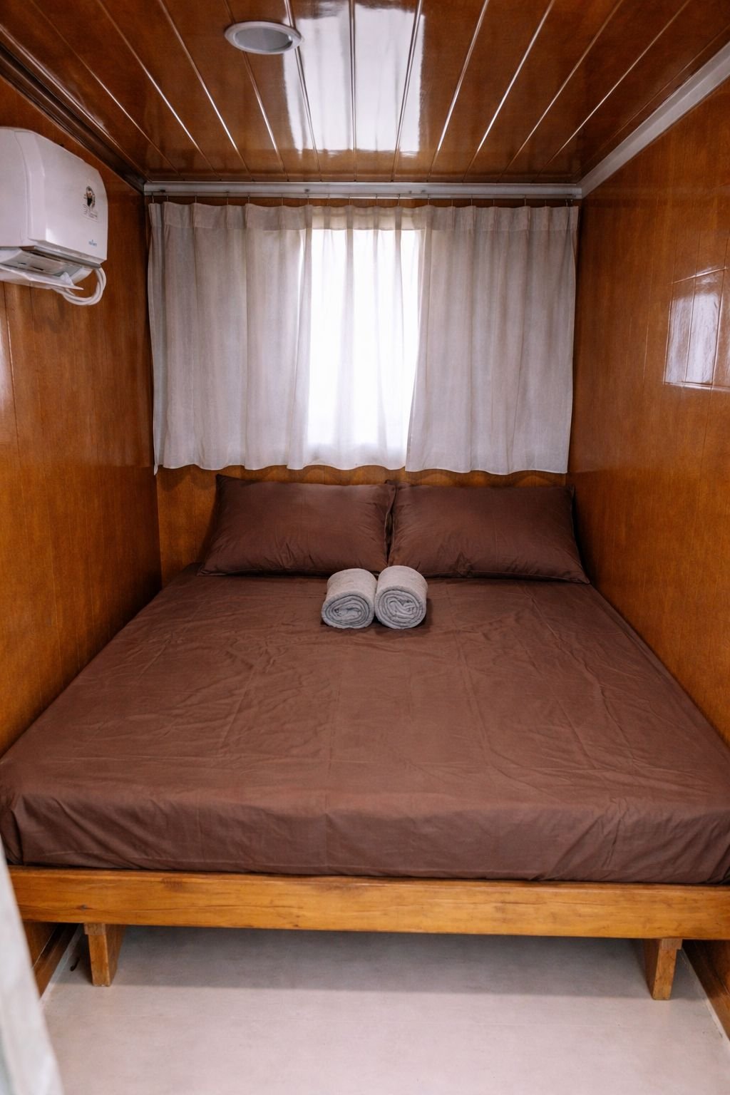 Private room — double bed with AC and towel — Labuan Bajo to Lombok budget open trip 4D3N